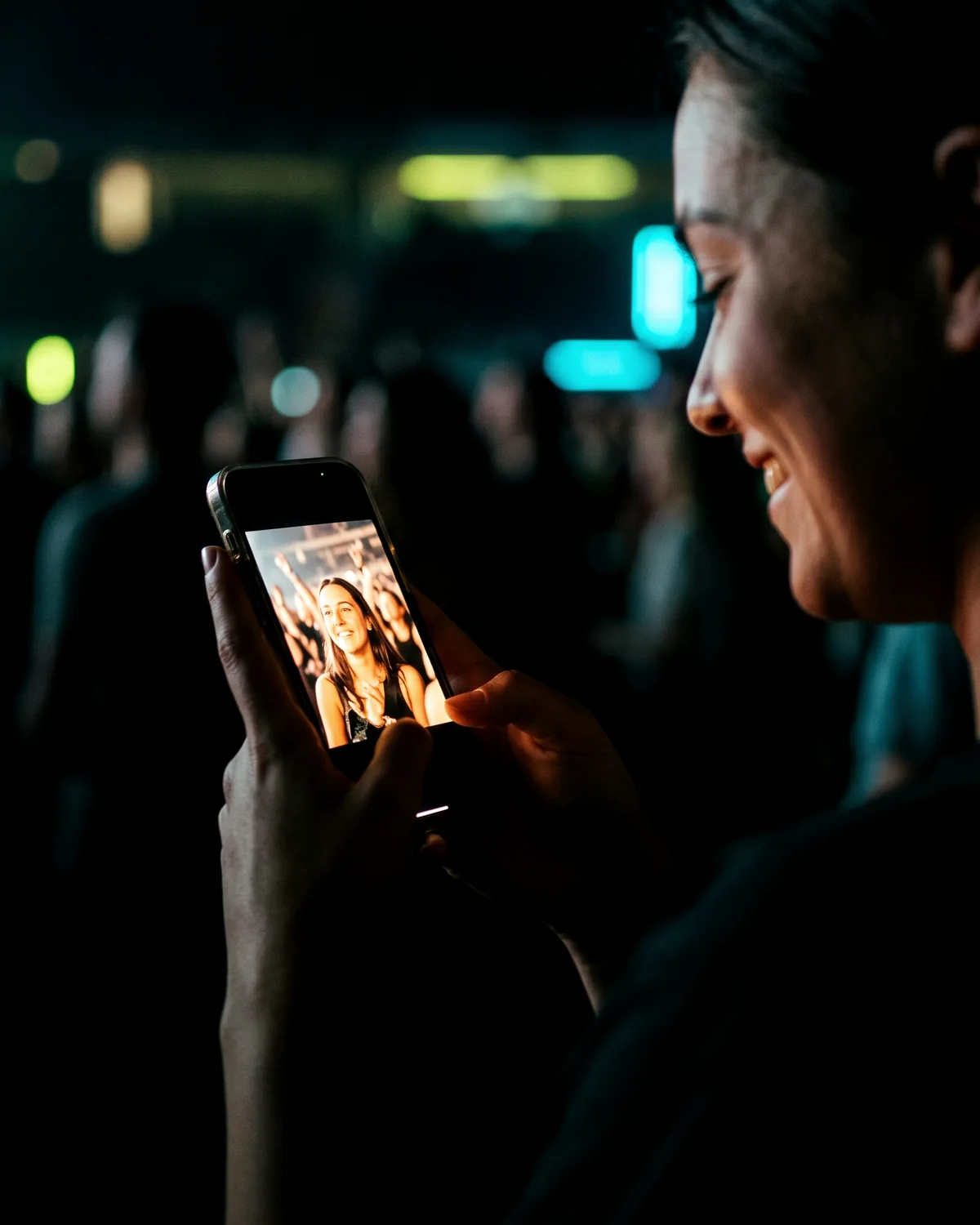 A fan holding a phone showing a saved professional photo